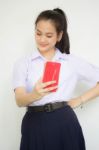 Portrait Of Thai High School Student Uniform Beautiful Girl Using Her Smart Phone Selfie Stock Photo