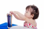 Little Girl Sitting And Choosing Colour Pencil , On White Backgr Stock Photo