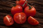 Organic Fresh Cherry Tomatoes On Wooden Background Stock Photo