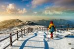 Young Woman Hiking With A Backpack On Mountains In Winter Stock Photo