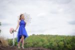 Beautiful Woman Wear Blue Evening Dress Hold A Bouquet Of Flower Stock Photo