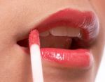 Girl Putting On Lip Gloss Stock Photo