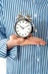 Boy Hand Holding Alarm Clock Stock Photo