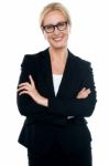 Businesswoman With Crossed Arms Wearing Glasses Stock Photo