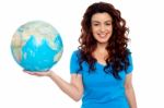 Smiling Girl Holding Globe Stock Photo