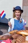 European Woman With Breads Waving With Dutch Flag Stock Photo