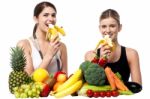 Young Smiling Girls Eating Banana Stock Photo