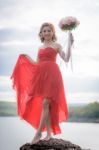 Beautiful Woman Wear Red Evening Dress Hold A Bouquet Of Flowers Stock Photo