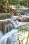 The Water Flowing Over Rocks And Trees Down A Waterfall At Huay Mae Khamin Waterfall National Park ,kanchana Buri In Thailand Stock Photo