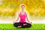 Beautiful Young Woman Practicing Yoga, Sitting In A Lotus Positi Stock Photo