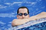 Male Swimmer Resting After Several Laps Stock Photo