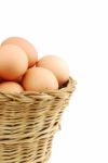 Close-up Of Eggs In A Wicker Basket On White Stock Photo