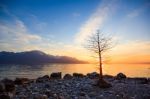 Sunset Over A Mountains Range Reflecting In A Lake Stock Photo