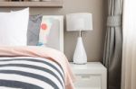 Kid's Bedroom With White Pillows And Lamp On Modern Bed Stock Photo