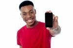 Young Guy Displaying Brand New Cellphone Stock Photo