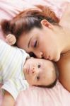 Hispanic Woman Kissing Newborn Stock Photo