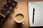 Hot Coffee With Guitar And Notepad Break Time For Thinking Idea Stock Photo