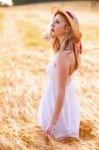 Lonely Beautiful Young Blonde Girl In White Dress With Straw Hat Stock Photo