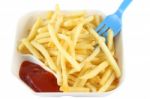 French Fries With Red Ketchup And Blue Spoon On Top Right Stock Photo