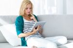 Pretty Young Woman Using Her Digital Tablet At Home Stock Photo