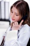 Female Physician Talking Over Phone Stock Photo