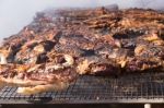 Traditional Meat Grilled On The Grill In The Argentine Countryside Stock Photo