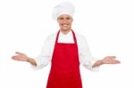 Male Chef Showing Welcome Gesture Stock Photo