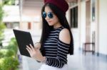 Portrait Of Thai Teen Beautiful Girl Using Her Tablet Stock Photo