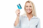 Smiling Female Model Holding Up Credit Card Stock Photo