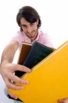 Smiling Male Showing Books Stock Photo