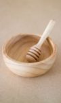 Wooden Bowl And Dipper On Brown Background Stock Photo