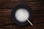 Black Empty Bowl Spoon On Wooden Table Background Stock Photo