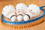 Close Up White Shuttlecock On Wooden Background Stock Photo