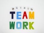 Miniature Bussinessman With Teamwork Word Letters On White Backg Stock Photo