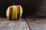 An Apple Surrounded By A Measuring Tape Tailor On Wood Stock Photo