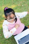 Cute Girl Is Happy With Notebook On Grass Stock Photo