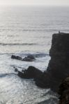 Lonely Man On Cliff Stock Photo