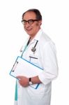 Senior Doctor Holding Clipboard Stock Photo