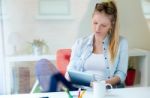 Young Beautiful Woman Using Her Digital Tablet At Home Stock Photo