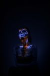 Girl's Face Painted Uv Skull Stock Photo