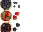 Fresh Summer Fruits, Cherry, Strawberry, And Blueberry In Wooden Stock Photo