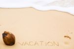 Inscription Of Word Vacation Written On Wet Yellow Beach Sand, F Stock Photo