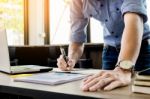 Young Business Man Working In Bright Office, Using Laptop, Writi Stock Photo