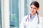 Happy Female Doctor With Stethoscope Around Neck Stock Photo