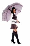 Full Body Pose Of Young Woman Holding An Umbrella Stock Photo