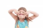 Little Girl Making Funny Face, Isolated On White Stock Photo