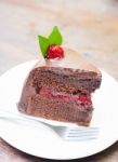 Piece Of Chocolate Cake On White Plate Stock Photo