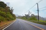 Asphalt Road On Mountain With Natural Fog And Forest Stock Photo