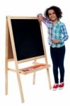 Happy Girl Resting Her Hand On Blackboard Stock Photo