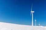 Wind Turbine And Blue Sky In Winter Landscape Stock Photo